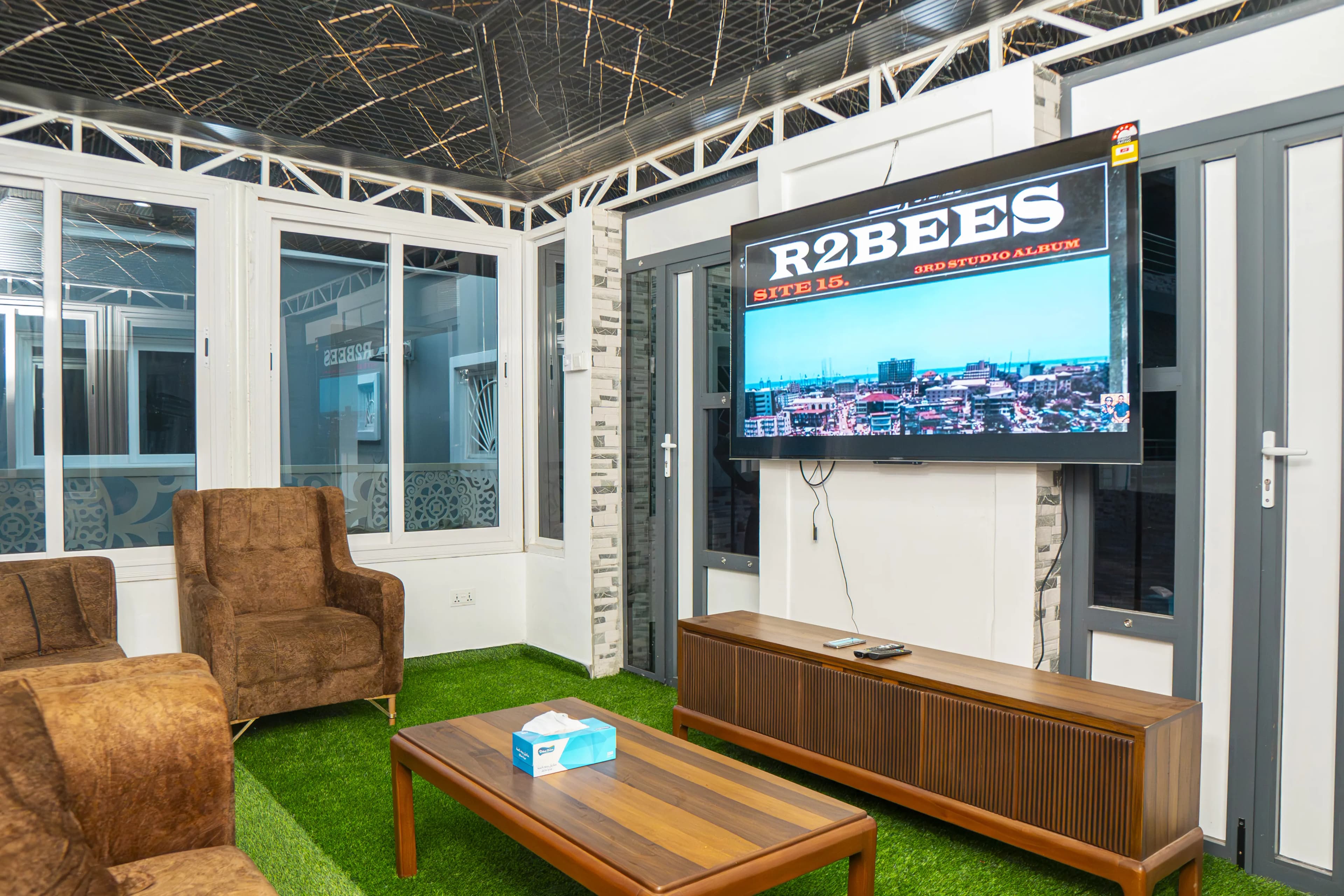 Diamond Edge Apartments shared lounge with a wall-mounted TV and seating
